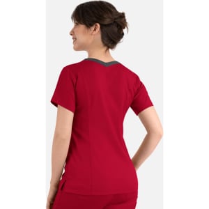 A red women's top with a contrast double V-neck and a branding logo, viewed from the back.