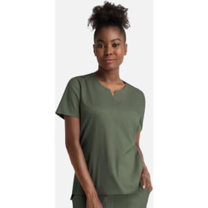 A woman wears a green notched crew neck top with short sleeves and a relaxed fit, featuring a subtle branding.