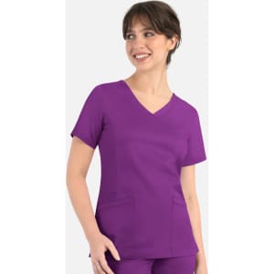 A purple curved mock wrap top with short sleeves and pockets, worn by a smiling model.