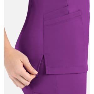 A purple mock wrap top featuring side pockets and a slit detail for added style. It includes a logo.