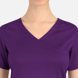 A purple women's curved mock wrap top with a V-neck and short sleeves. Features a small logo on the shoulder.