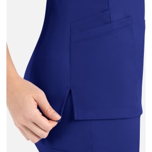 A women's curved mock wrap top in a vibrant blue colour, featuring pockets and a side slit detail.