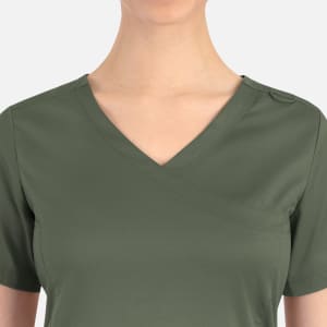 A women's curved mock wrap top in olive green, featuring a V-neck and a logo on the shoulder.