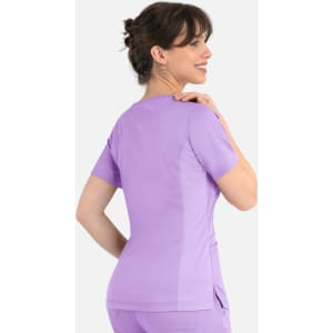 A women's curved mock wrap top in lilac with short sleeves and a fitted design, featuring a logo.