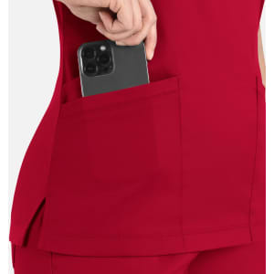 A red curved mock wrap top featuring a pocket demonstrating a phone being placed inside.
