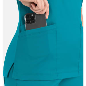 A teal women's curved mock wrap top featuring a pocket with a smartphone tucked inside.
