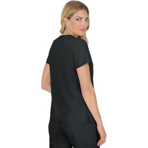 A black top with short sleeves, featuring a side slit, worn by a woman facing slightly backward.