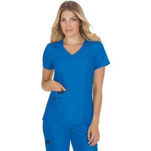A woman models a blue scrubs top with a V-neck design and pockets, featuring a branding logo.