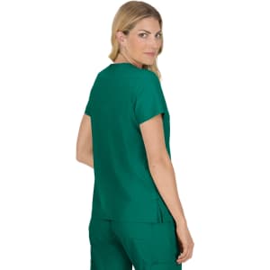 A woman wearing a teal Becca Top, showcasing the back view. The top has short sleeves and a relaxed fit.