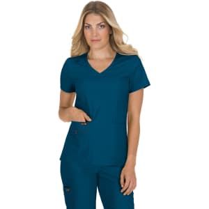 A woman in a teal scrub top with a v-neck and short sleeves, featuring pockets.