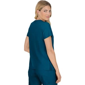 A teal-coloured women's top with short sleeves and a back pleat, featuring a logo on the back.