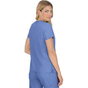 A woman wearing a blue medical tunic, viewed from the back, featuring short sleeves and a relaxed fit.