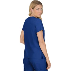 A blue medical top is worn by a model, showing the back view and a relaxed fit. The top features a logo.