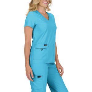 A vibrant teal scrub top worn by a model, featuring a V-neck and two front pockets. The top has a logo.