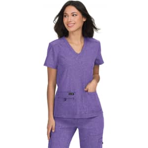 A purple scrubs top with a V-neck and two front pockets, featuring branding on the side.