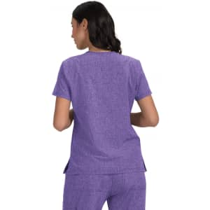A purple shirt with short sleeves and a rounded neckline, featuring a classic cut and side slits.