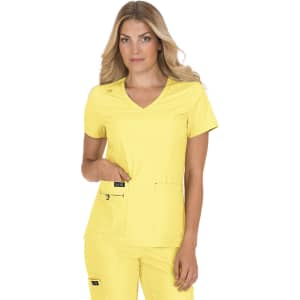 A top in bright yellow fabric, featuring a V-neck and two front pockets, worn by a model. The design includes a logo.