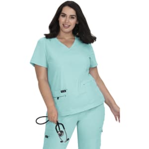 A model wearing a turquoise medical scrubs top, featuring a V-neck design and a logo on the pocket.