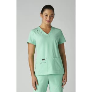 A mint green medical top with a V-neck design and two front pockets, worn by a model. It features a logo.