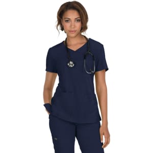 A navy scrub top with a v-neck design, featuring pockets and a stethoscope draped around the neck.