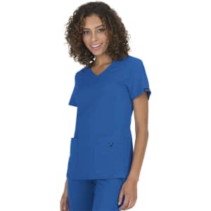 A model wearing a bright blue scrub top with two pockets and a logo on the sleeve.