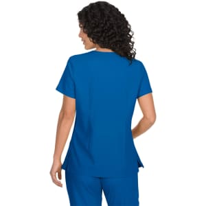 A blue top featuring short sleeves and a curved hem, worn by a person with curly hair from the back.