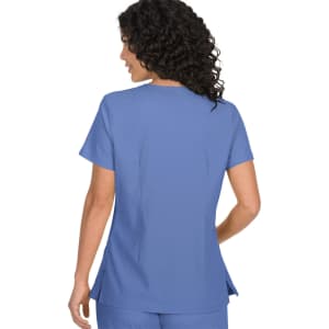 A scrub top in a light blue colour, featuring a simple design and short sleeves, with a logo present.