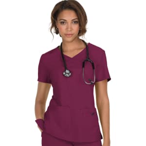 A scrub top in a rich burgundy colour, featuring two front pockets and a V-neck design, worn by a model with a stethoscope.