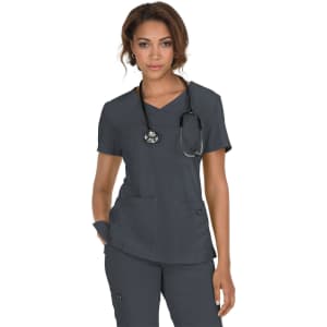 A dark grey medical scrubs top with a V-neck and two front pockets, worn by a model with a stethoscope.