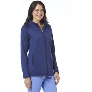 A woman wearing a navy fleece jacket with a zip front and side pockets, featuring a logo.