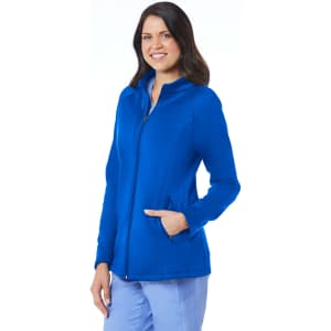 A woman wearing a blue fleece jacket with a zip and pockets, featuring a logo on the design.