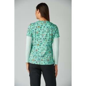 A printed green top featuring floral and animal patterns, designed with short sleeves and a round neckline.