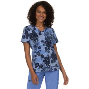 A floral print top in blue with black accents, featuring a V-neck and short sleeves. The model has curly hair and a smile.