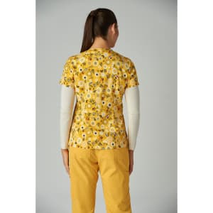 A floral print top in yellow with a back view, featuring a vibrant design and a logo on the side.