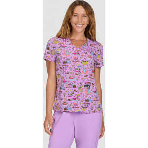 A purple printed top featuring a playful pattern, with a V-neckline and short sleeves. The model is smiling.