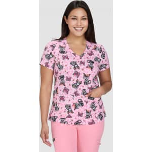 A pink patterned top featuring butterflies and floral designs, with a V-neck and short sleeves.