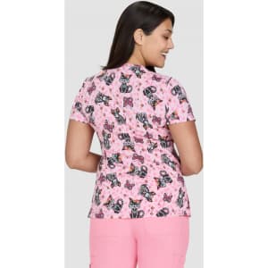 A short-sleeved top featuring a pink butterfly print, designed with a fitted silhouette and a branded logo.