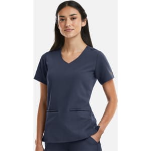 A navy women's V-neck top featuring metallic details and two front pockets, with a branding logo on the sleeve.