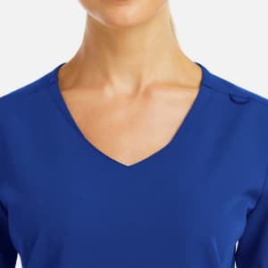 A women's blue V-neck top featuring a curved design and subtle metallic detailing. It has a branding logo.