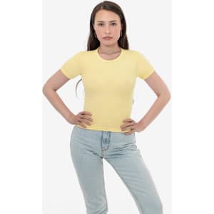 A yellow short-sleeve ribbed t-shirt displayed on a model, paired with light blue jeans. The shirt features branding.