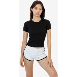 A black short-sleeved t-shirt displayed on a model paired with white shorts. The shirt features a logo.