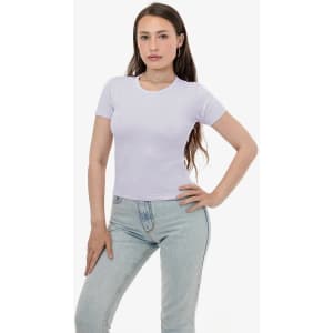 A light purple fitted t-shirt with short sleeves, modelled by a person in light blue jeans. The shirt features a logo.