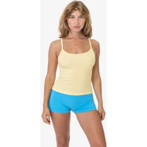 A yellow spaghetti tank top paired with blue shorts, featuring a branding logo.