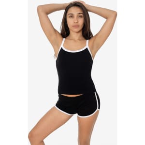 A black spaghetti tank top with white trim, displayed by a model wearing matching black shorts.