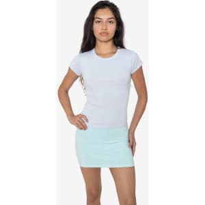A model wearing a light blue cap sleeve baby tee paired with a mint green mini skirt. The shirt features a logo.