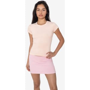 A cap sleeve baby tee in soft pink, paired with a matching pink skirt. The shirt features a logo.