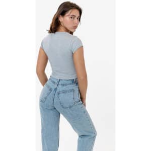 A grey cap sleeve baby rib crop top displayed on a model, paired with light blue jeans. The top features a fitted design.