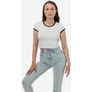 A cropped white shirt with black trim, paired with light blue high-waisted jeans, displayed on a model.