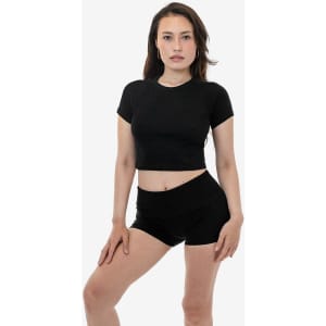 A black short sleeve ribbed tee paired with black shorts, modelled by a female. The top has a fitted design.
