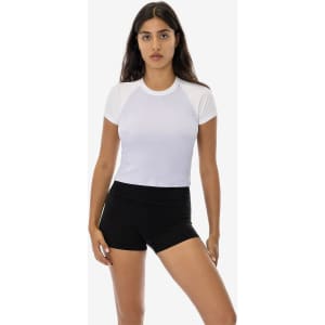 A short sleeve baby rib raglan tee in white, paired with black shorts, featuring a simple design and a logo.